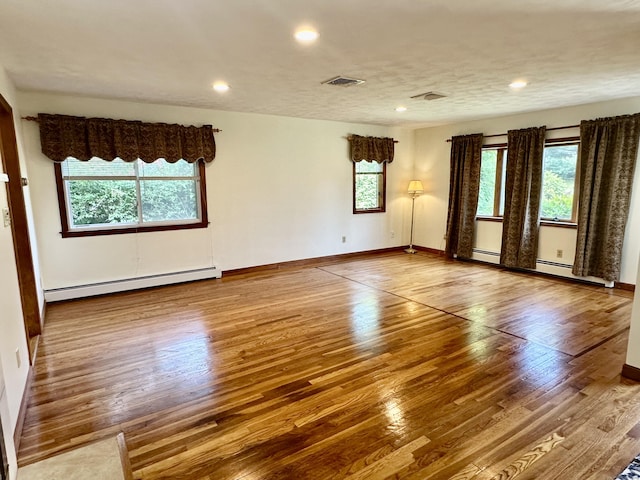 846 Sawmill Rd, West Haven, CT 06516 - spare room with a baseboard heating unit, wood finished floors, and recessed lighting