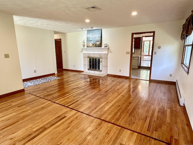 846 Sawmill Rd, West Haven, CT 06516 - unfurnished living room with baseboard heating, light wood-style flooring, a fireplace, and recessed lighting