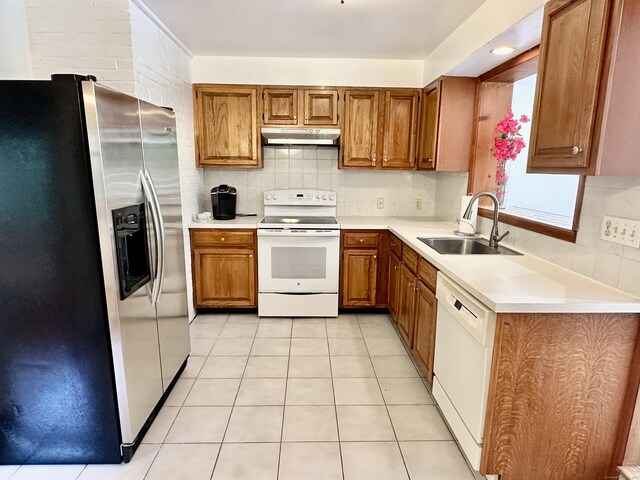 846 Sawmill Rd, West Haven, CT 06516 - kitchen with white appliances, under cabinet range hood, brown cabinets, tasteful backsplash, and light countertops