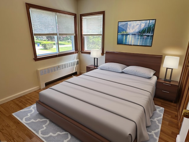 846 Sawmill Rd, West Haven, CT 06516 - bedroom with radiator heating unit and wood finished floors