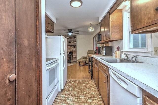 17 Brush Hill Rd, Clinton, CT 06413 - kitchen with white appliances, a ceiling fan, light countertops, a fireplace, and brown cabinets