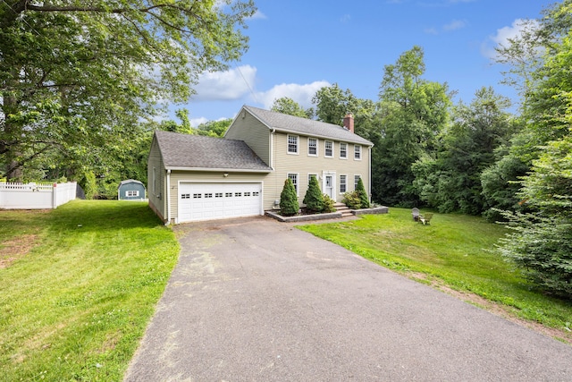 1 Brook Hill Rd, Hamden, CT 06514 - colonial house featuring a chimney, asphalt driveway, and an attached garage