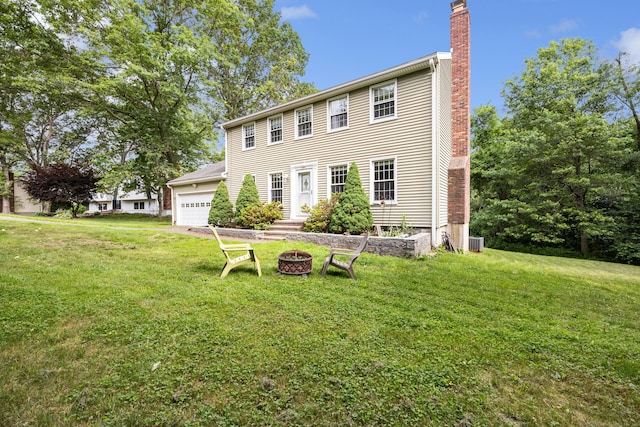 1 Brook Hill Rd, Hamden, CT 06514 - colonial home featuring a chimney, a garage, a front lawn, and an outdoor fire pit
