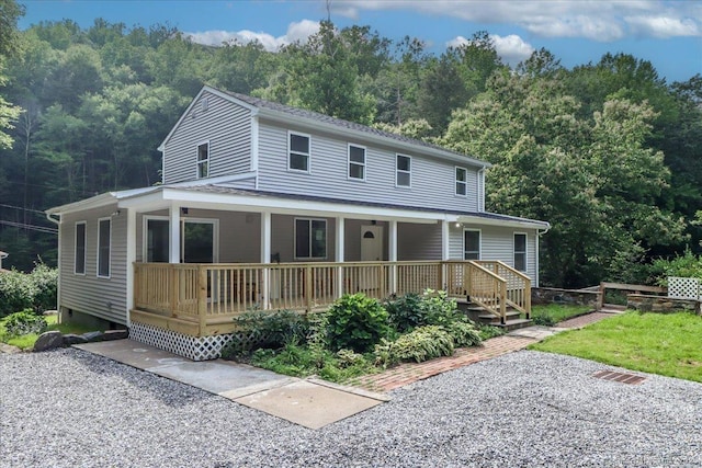 3 Brookside Trl, Monroe, CT 06468 - farmhouse-style home with a porch and a wooded view