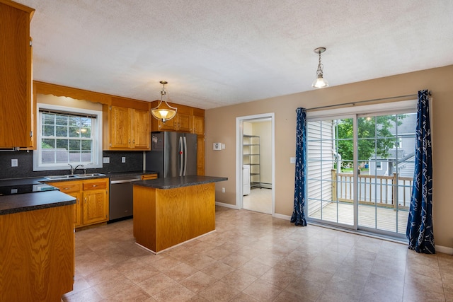 46 Dewey St, Middletown, CT 06457 - kitchen featuring appliances with stainless steel finishes, a sink, dark countertops, a kitchen island, and healthy amount of natural light