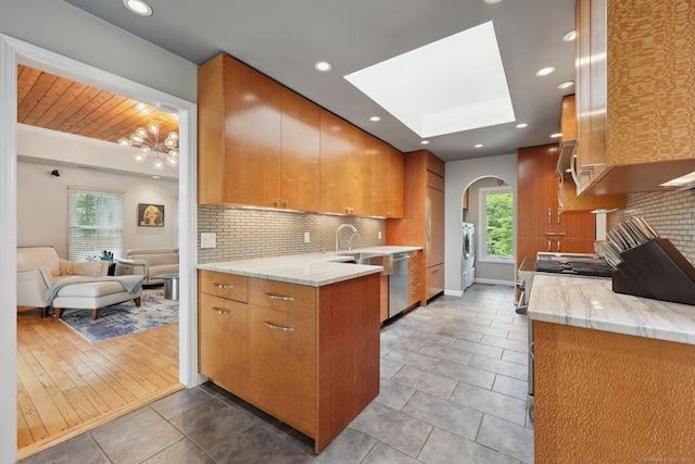 8 Highview Rd, Madison, CT 06443 - kitchen with arched walkways, brown cabinetry, backsplash, healthy amount of natural light, and recessed lighting