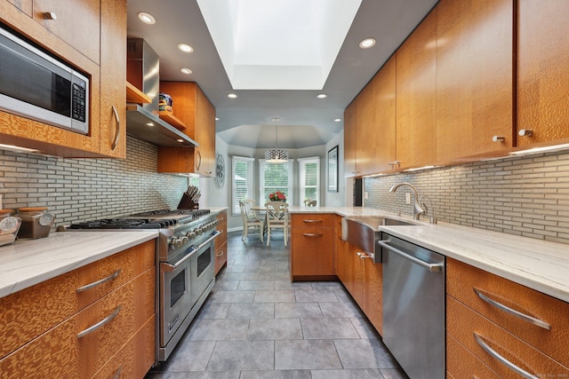 8 Highview Rd, Madison, CT 06443 - kitchen featuring stainless steel appliances, tasteful backsplash, wall chimney range hood, recessed lighting, and brown cabinetry