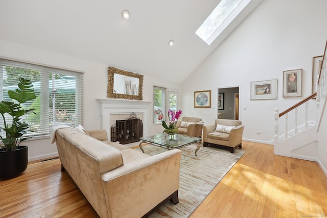 8 Highview Rd, Madison, CT 06443 - living area featuring healthy amount of natural light, light wood-type flooring, a tiled fireplace, high vaulted ceiling, and recessed lighting