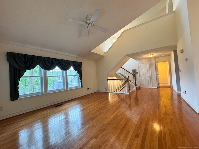 21 Rivendell Dr Unit 21, Shelton, CT 06484 - unfurnished living room with ceiling fan, hardwood / wood-style floors, stairway, and high vaulted ceiling