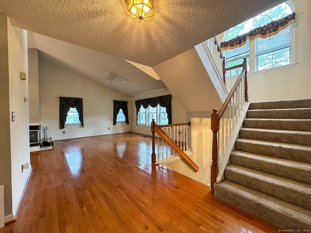 21 Rivendell Dr Unit 21, Shelton, CT 06484 - unfurnished living room with hardwood / wood-style flooring, stairway, a textured ceiling, a ceiling fan, and lofted ceiling