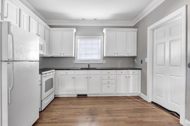 240 Highland Ave, Stratford, CT 06614 - kitchen featuring white appliances, white cabinets, dark countertops, wood finished floors, and crown molding