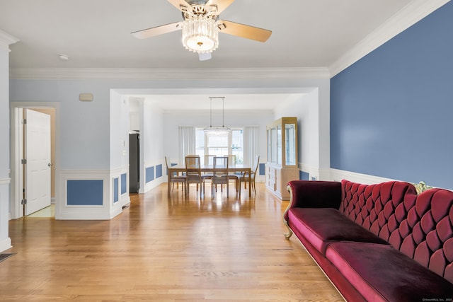 240 Highland Ave, Stratford, CT 06614 - living area with a ceiling fan, light wood-style floors, ornamental molding, and a wainscoted wall
