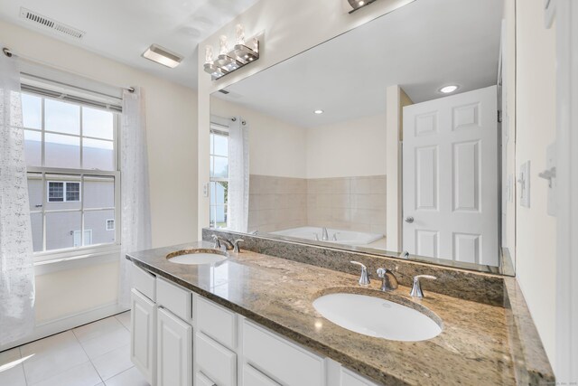 240 Highland Ave, Stratford, CT 06614 - full bathroom with tile patterned floors, a bath, and double vanity
