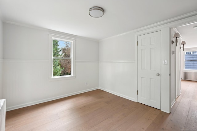 37 Cedar Crest Pl, Norwalk, CT 06854 - spare room with radiator, light wood finished floors, a wainscoted wall, and crown molding