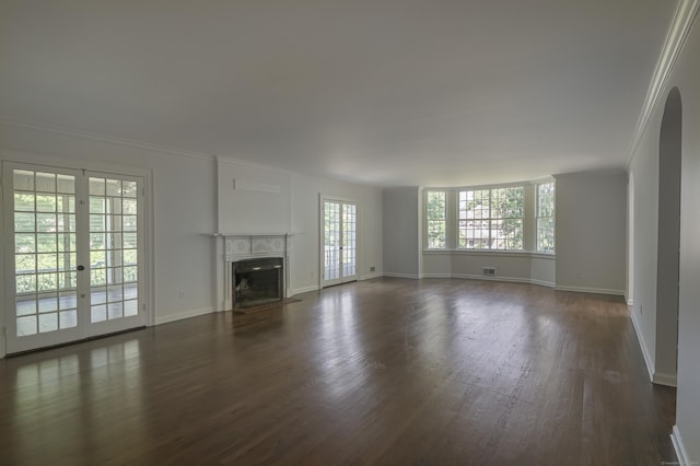563 Main St, Ridgefield, CT 06877 - unfurnished living room featuring crown molding, dark wood-style floors, baseboards, a fireplace with flush hearth, and french doors