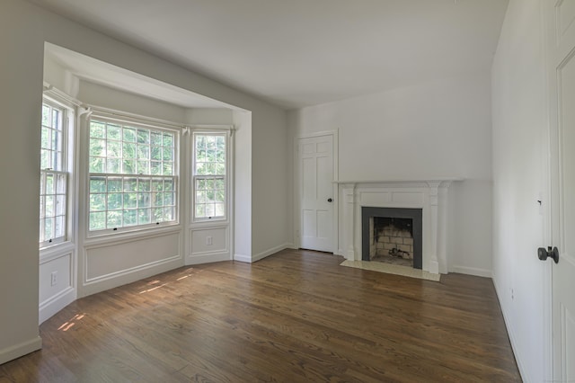 563 Main St, Ridgefield, CT 06877 - unfurnished living room featuring wood finished floors, a fireplace with flush hearth, and baseboards