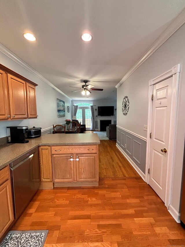 401 Cambridge Commons Unit 401, Middletown, CT 06457 - kitchen with stainless steel dishwasher, ornamental molding, a peninsula, a ceiling fan, and a fireplace