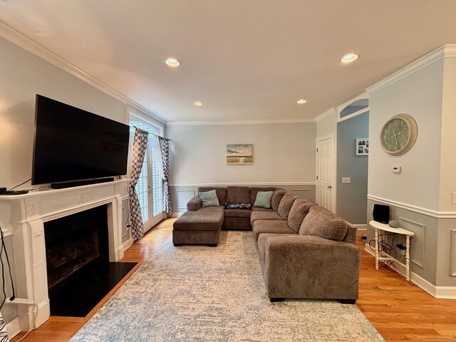 401 Cambridge Commons Unit 401, Middletown, CT 06457 - living area featuring ornamental molding, light wood finished floors, a wainscoted wall, a fireplace with flush hearth, and recessed lighting