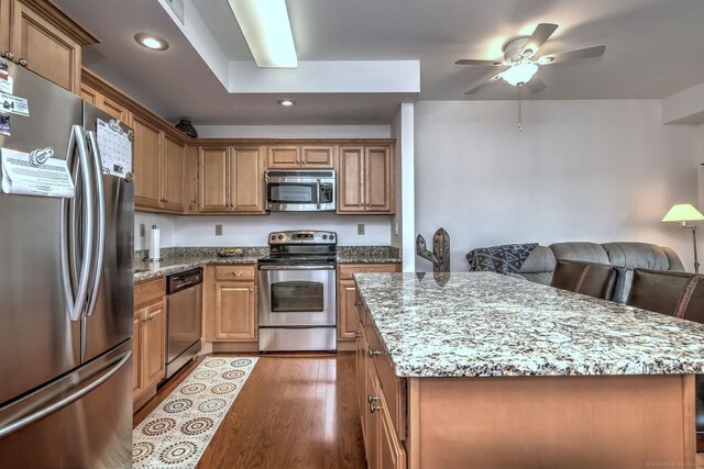 510 First Ave Unit 306, West Haven, CT 06516 - kitchen with stainless steel appliances, recessed lighting, ceiling fan, light stone counters, and a kitchen island