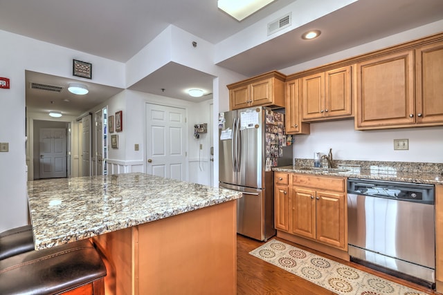 510 First Ave Unit 306, West Haven, CT 06516 - kitchen with appliances with stainless steel finishes, dark wood finished floors, light stone countertops, and brown cabinets