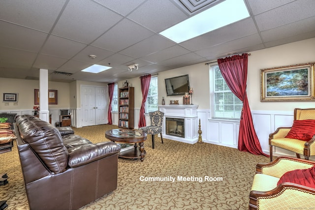 510 First Ave Unit 306, West Haven, CT 06516 - living area featuring a drop ceiling, a fireplace, carpet flooring, and a wainscoted wall