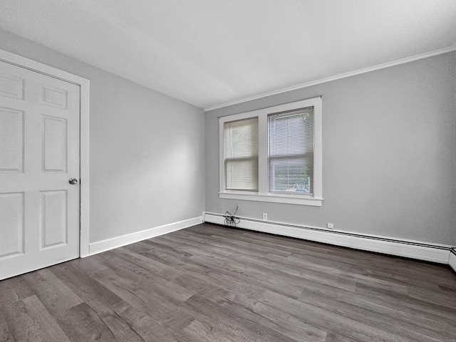 38 Hammond St, Vernon, CT 06066 - empty room featuring baseboard heating, dark wood-type flooring, and crown molding