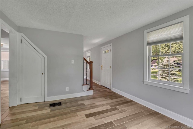 57 Whitney Rd, Columbia, CT 06237 - spare room featuring light wood finished floors, stairway, and a textured ceiling