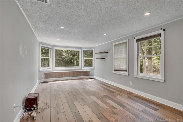 57 Whitney Rd, Columbia, CT 06237 - unfurnished room featuring crown molding, a textured ceiling, healthy amount of natural light, wood finished floors, and recessed lighting