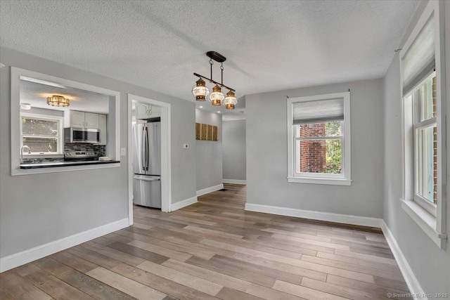 57 Whitney Rd, Columbia, CT 06237 - unfurnished dining area with wood finished floors and a textured ceiling