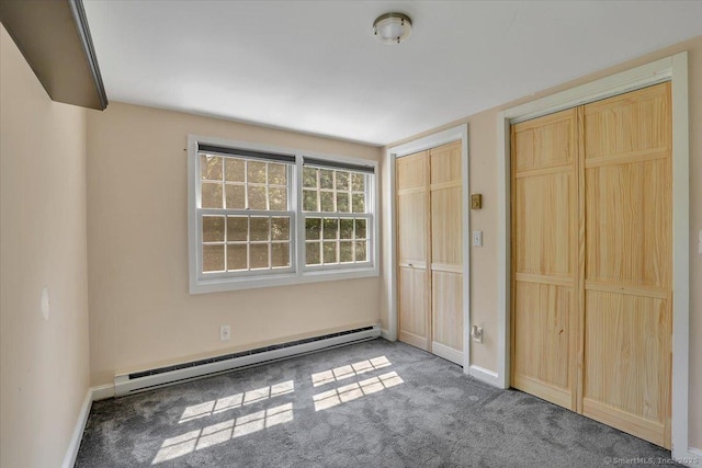 57 Whitney Rd, Columbia, CT 06237 - unfurnished bedroom featuring a baseboard heating unit, carpet floors, and two closets