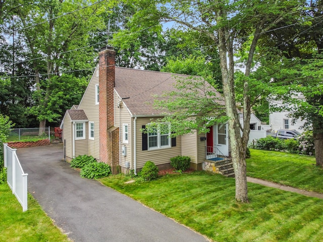51 Goodwin St, Manchester, CT 06040 - view of front of home with a shingled roof, driveway, a chimney, and view of wooded area