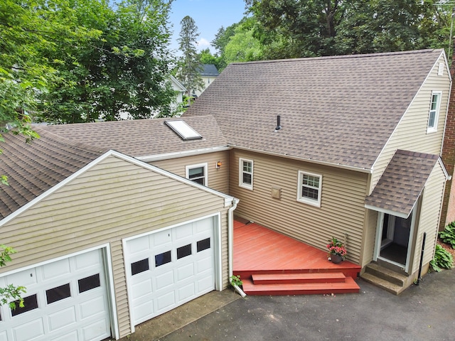 51 Goodwin St, Manchester, CT 06040 - back of property with roof with shingles, a deck, a garage, and driveway