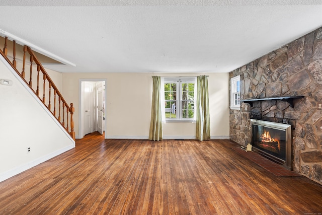 51 Goodwin St, Manchester, CT 06040 - unfurnished living room featuring wood finished floors, a stone fireplace, and stairs