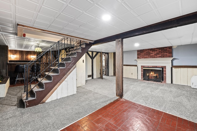 51 Goodwin St, Manchester, CT 06040 - finished basement with stairs, wood walls, a wainscoted wall, carpet floors, and a brick fireplace