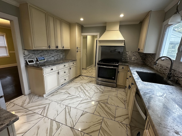 82 Trowbridge Pl, Naugatuck, CT 06770 - kitchen featuring appliances with stainless steel finishes, premium range hood, ornamental molding, cream cabinetry, and decorative backsplash