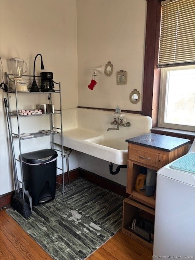 1085 Hamilton Ave, Waterbury, CT 06706 - bathroom featuring wood finished floors, washer / clothes dryer, and baseboards