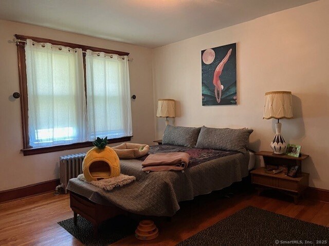 1085 Hamilton Ave, Waterbury, CT 06706 - bedroom with radiator heating unit, wood finished floors, and baseboards
