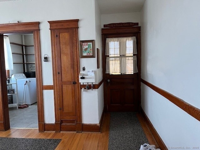 1085 Hamilton Ave, Waterbury, CT 06706 - doorway with washer and clothes dryer and wood finished floors
