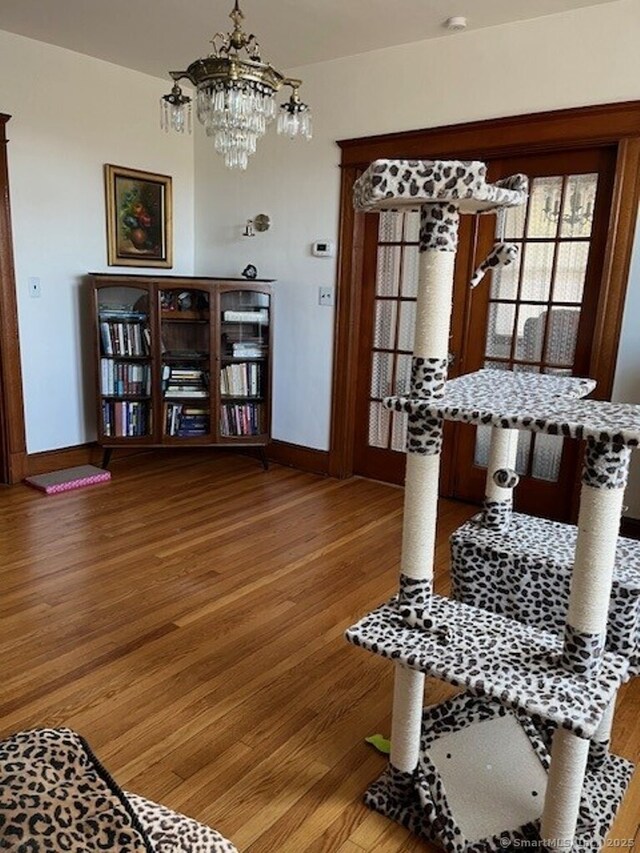 1085 Hamilton Ave, Waterbury, CT 06706 - dining space featuring wood finished floors, a chandelier, and baseboards