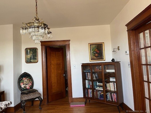 1085 Hamilton Ave, Waterbury, CT 06706 - entryway featuring a chandelier, wood finished floors, and baseboards