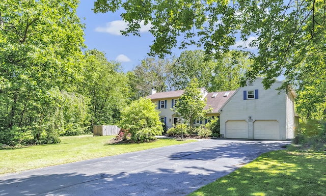 230 Tom Swamp Rd, Hamden, CT 06518 - view of front of house featuring asphalt driveway, a front lawn, a garage, and a chimney