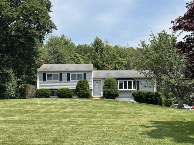 20 Celestial Ln, Wallingford, CT 06492 - tri-level home with a front lawn and a chimney