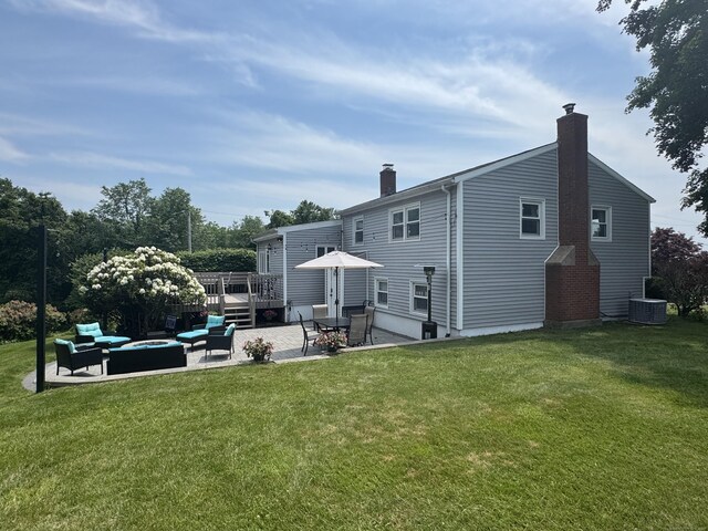 20 Celestial Ln, Wallingford, CT 06492 - rear view of property featuring a patio, a chimney, an outdoor living space with a fire pit, a wooden deck, and a yard
