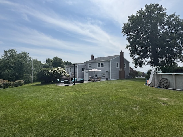 20 Celestial Ln, Wallingford, CT 06492 - back of house featuring a patio area, a chimney, and a yard