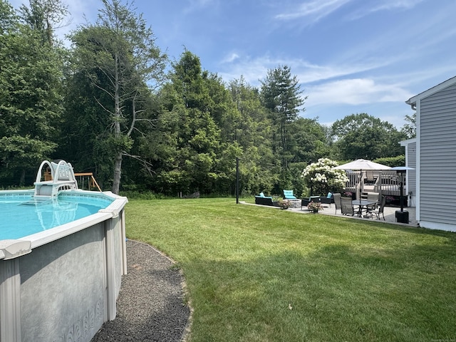 20 Celestial Ln, Wallingford, CT 06492 - view of green lawn featuring an outdoor pool, a patio, an outdoor living space, and a view of trees