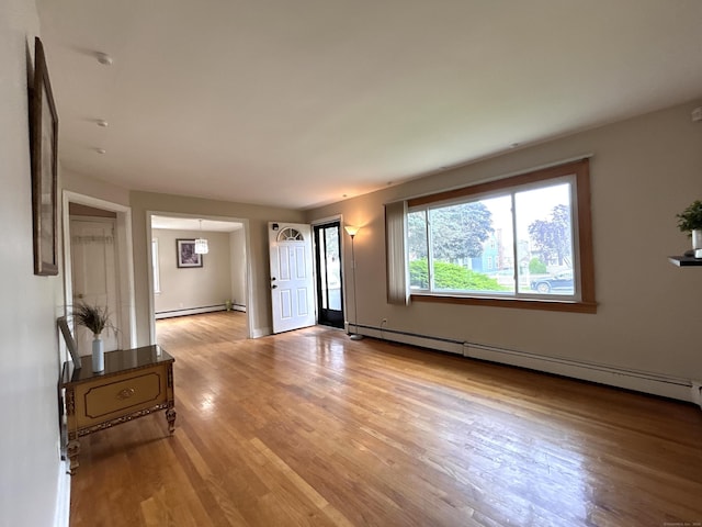 365 Ruth St, Bridgeport, CT 06606 - unfurnished living room with a baseboard radiator and light wood-style floors