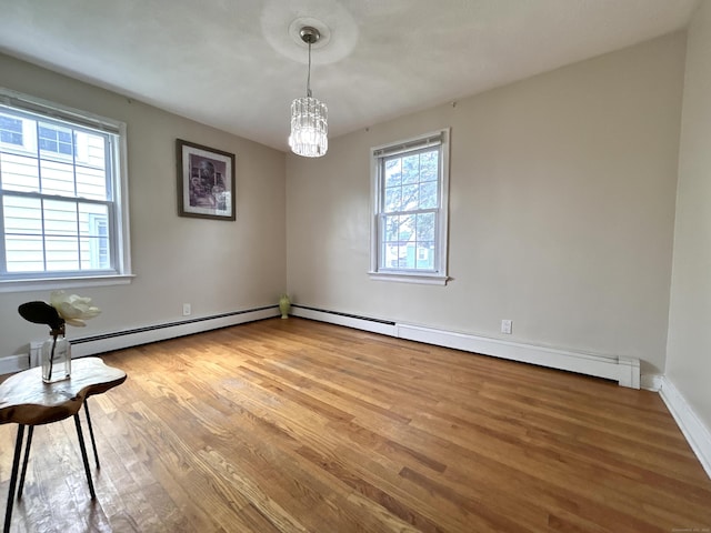 365 Ruth St, Bridgeport, CT 06606 - empty room with a chandelier and light wood finished floors