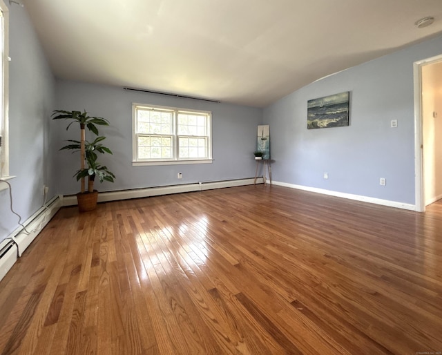 365 Ruth St, Bridgeport, CT 06606 - unfurnished room featuring vaulted ceiling, hardwood / wood-style flooring, a smoke detector, and a baseboard heating unit