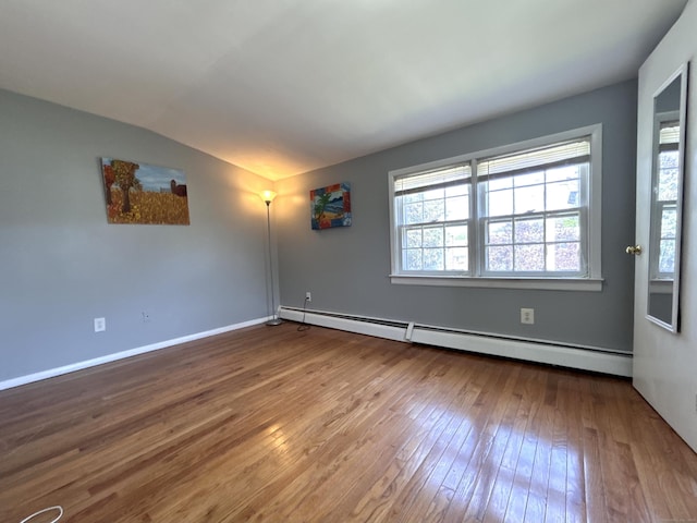 365 Ruth St, Bridgeport, CT 06606 - spare room featuring a baseboard heating unit, hardwood / wood-style flooring, and lofted ceiling