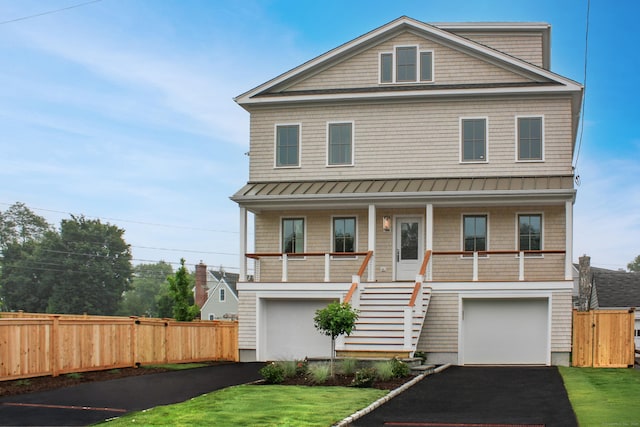 17 Benson Pl, Fairfield, CT 06824 - coastal home with a standing seam roof, covered porch, stairway, asphalt driveway, and a metal roof